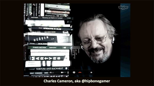 Charles Cameron in front of a stack of books on religious violence