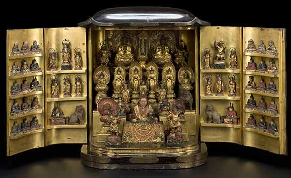 Cabinet shinto shrine, open to reveal dozens of golden god-figures