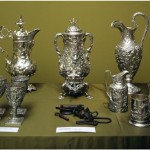 Display case containing fine silverware and slave shackles